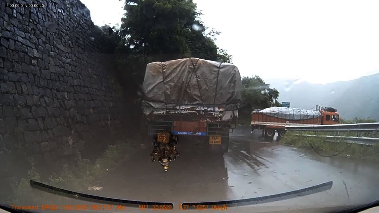 Car Overtaking Dangerously in a Tight Hairpin Curve