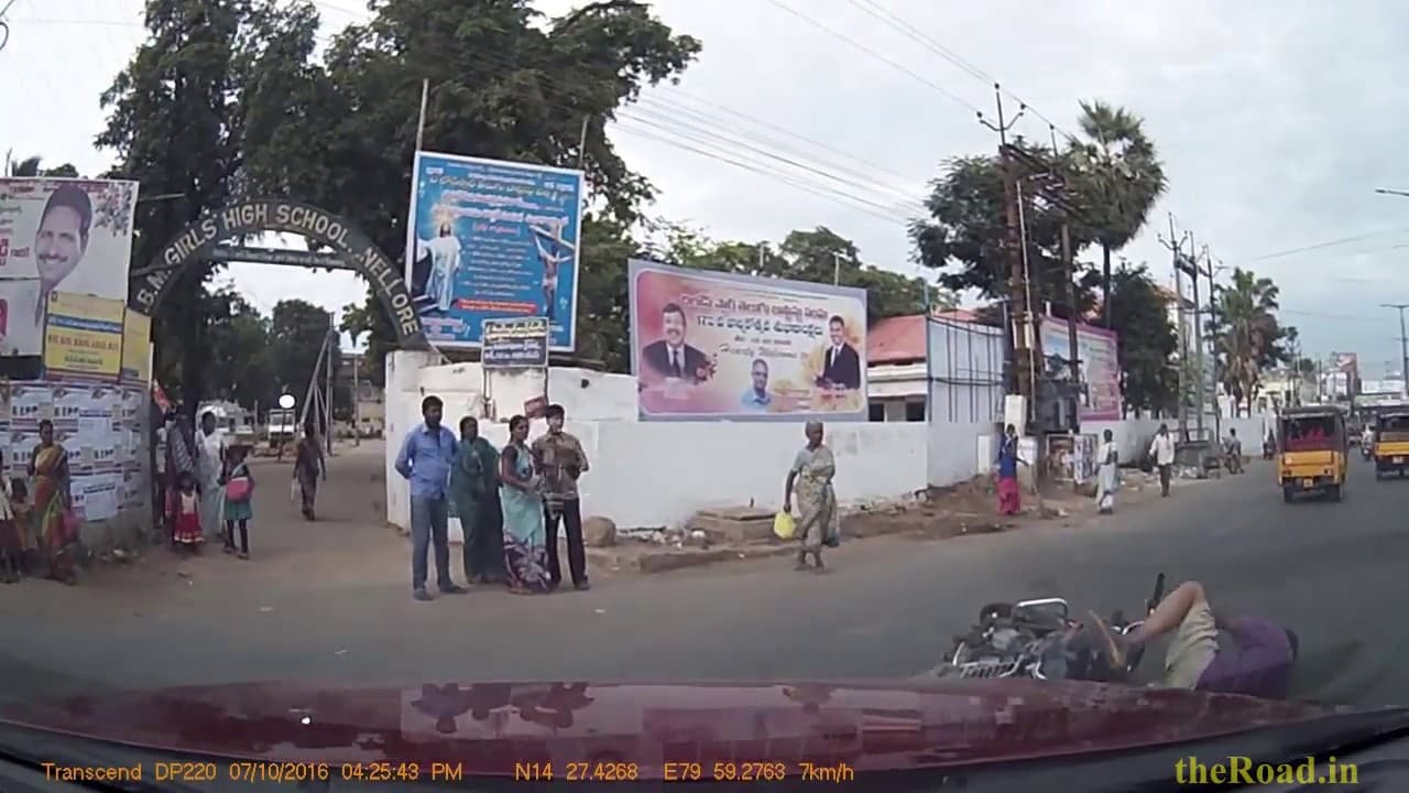 Motorcyclist skids while turning in front of a moving car
